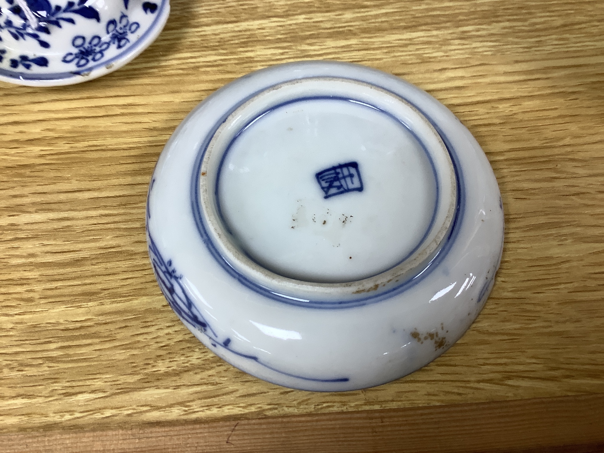 A pair of lidded Chinese blue and white vases, c.1900, Kangxi marks, 23cm high, together with two small Japanese vases, and a cup and saucer (6)